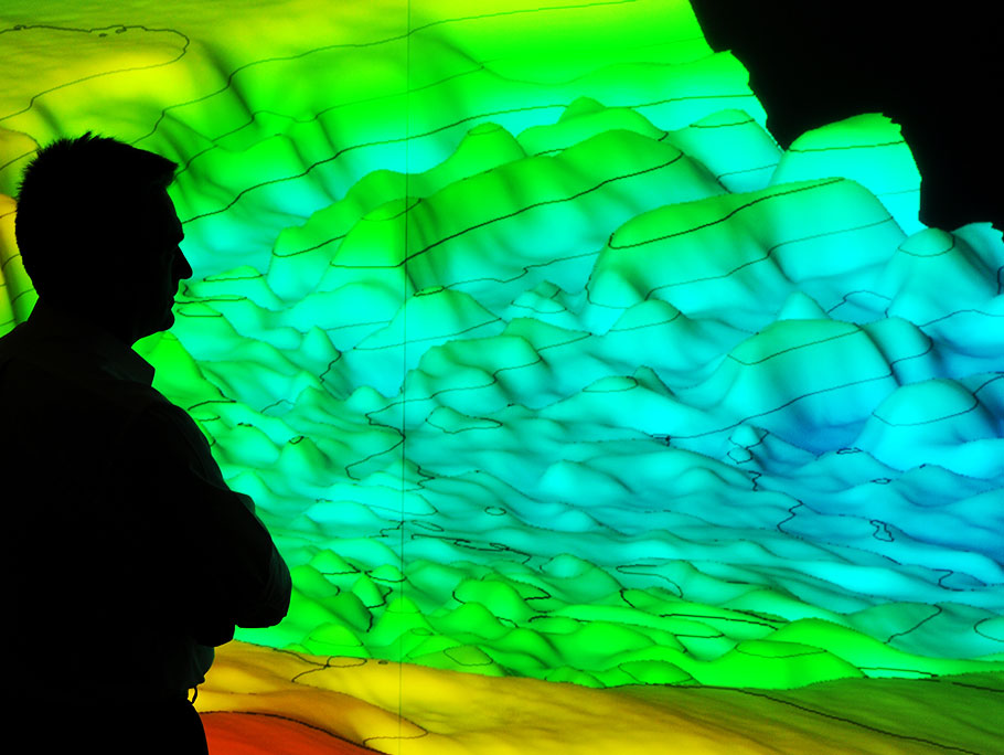 man standing in front of 3D seismic technology visualization 
